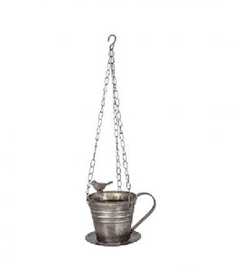 Lintu kahvikupin reunalla metallisessa amppelissa jossa kettingit ja koukku ripustamista varten La Petite Provence